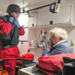 Ukrainian rescuers help a civilian affected by the Russian strikes on Kharkiv.