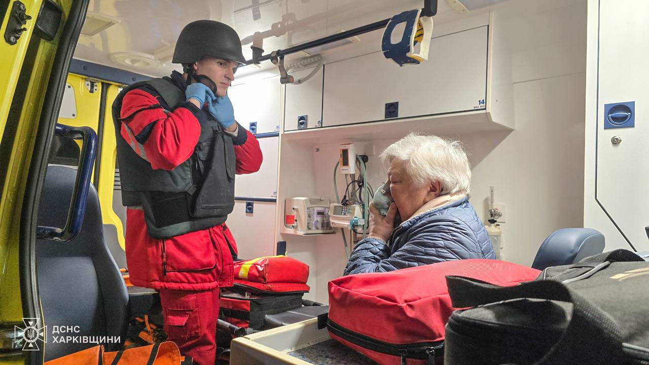 Ukrainian rescuers help a civilian affected by the Russian strikes on Kharkiv.