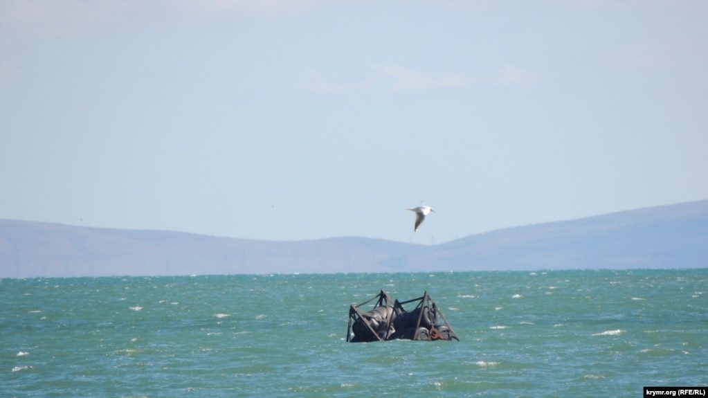 russian naval security barriers kerch bridge found floating near coast piece boom defenses drifting off