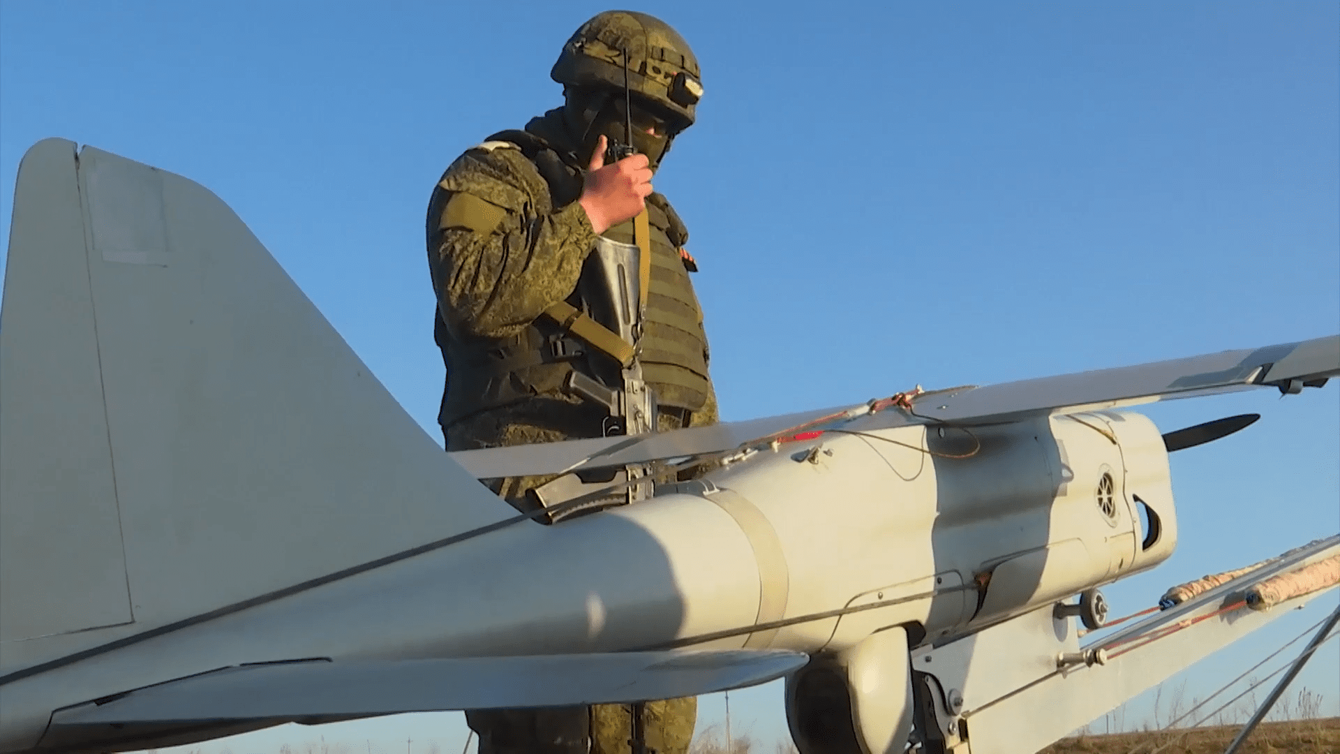 A Russian soldier standing next to an Orlan-10 uncrewed aerial reconnaissance vehicle. Photo via Wikimedia.