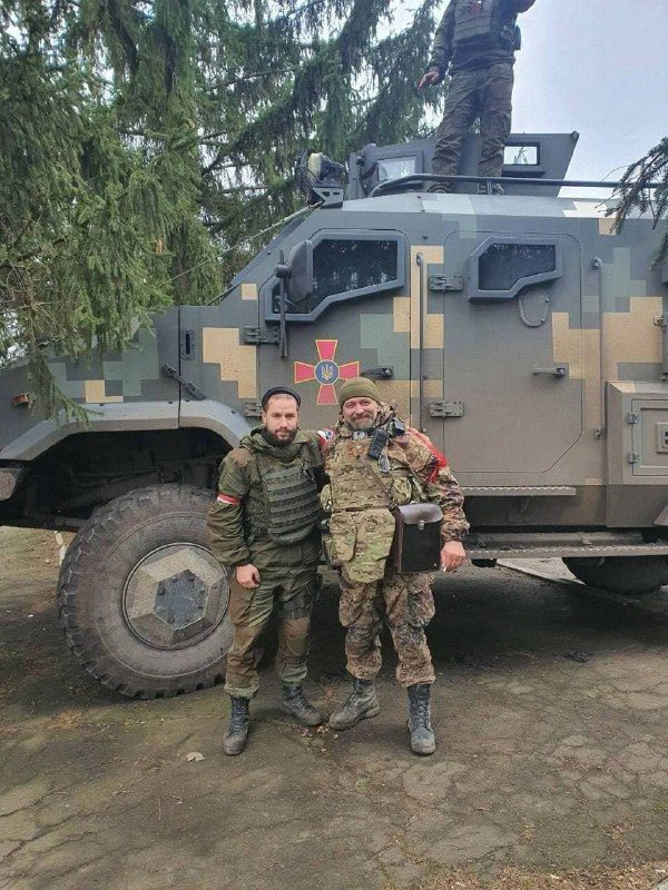 Soldiers of the "Sparta" battalion (DPR) with a captured Ukrainian armored car ...