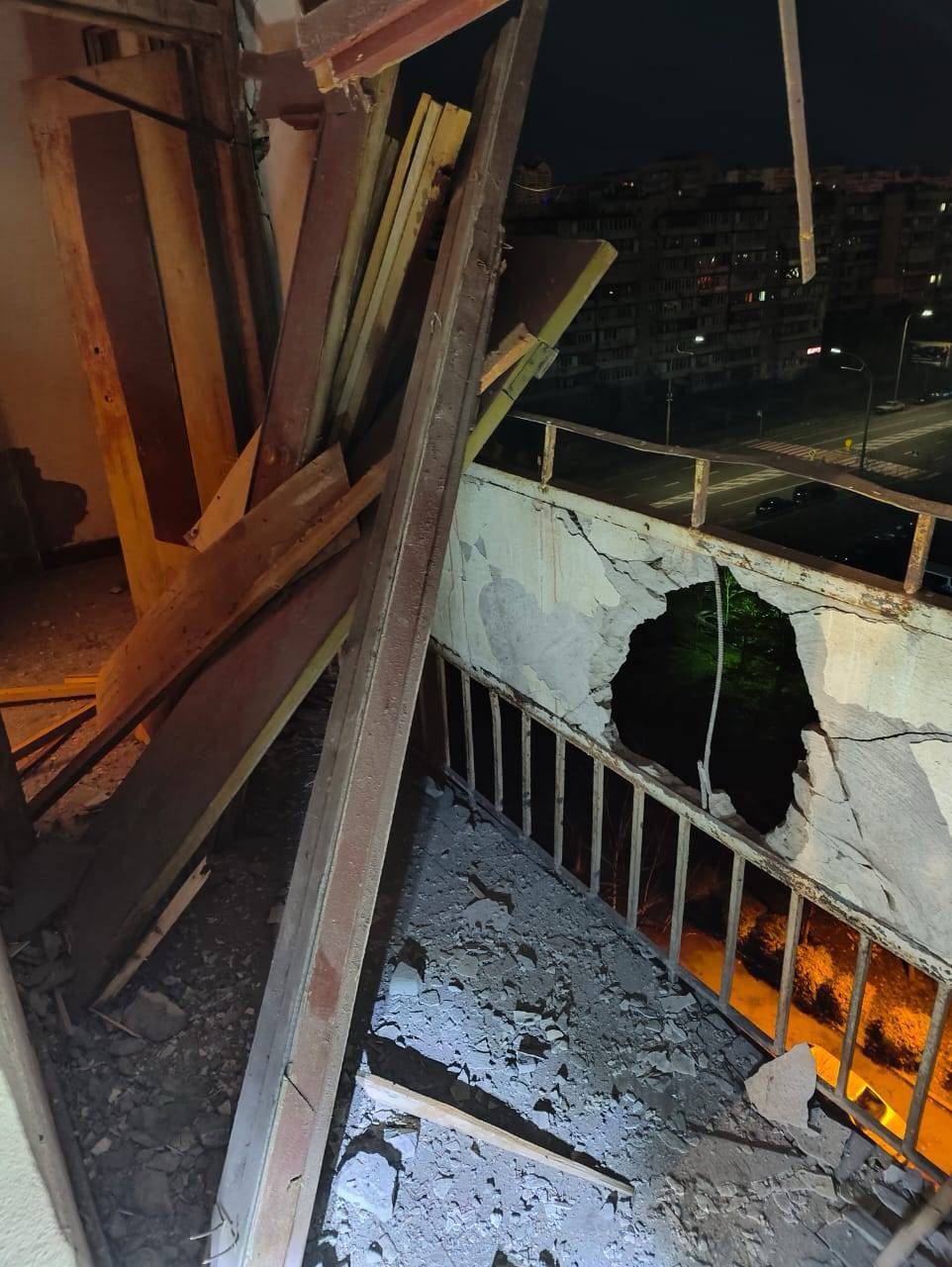 falling debris from intercepted Russian drones damaged balconies and windows of a multi-story residential building in Kyiv.