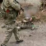 Russians execute unarmed, wounded Ukrainian POW on camera.