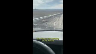 Russian Drives Down a Graveyard of Wrecked Vehicles in Kursk,